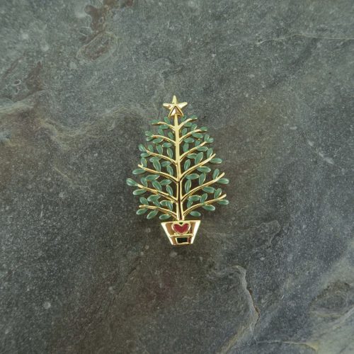 Alexander Thurlow Festive Christmas Tree on a book with a candle in the background