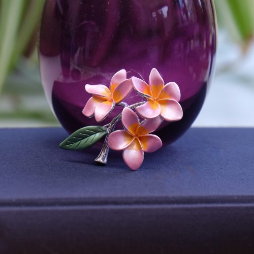 Alexander Thurlow x Kew Botanical Gardens Jasmin Mango Flower Brooch inspired by Marianne North on a Book with a Purple Vase in the Background ATH974